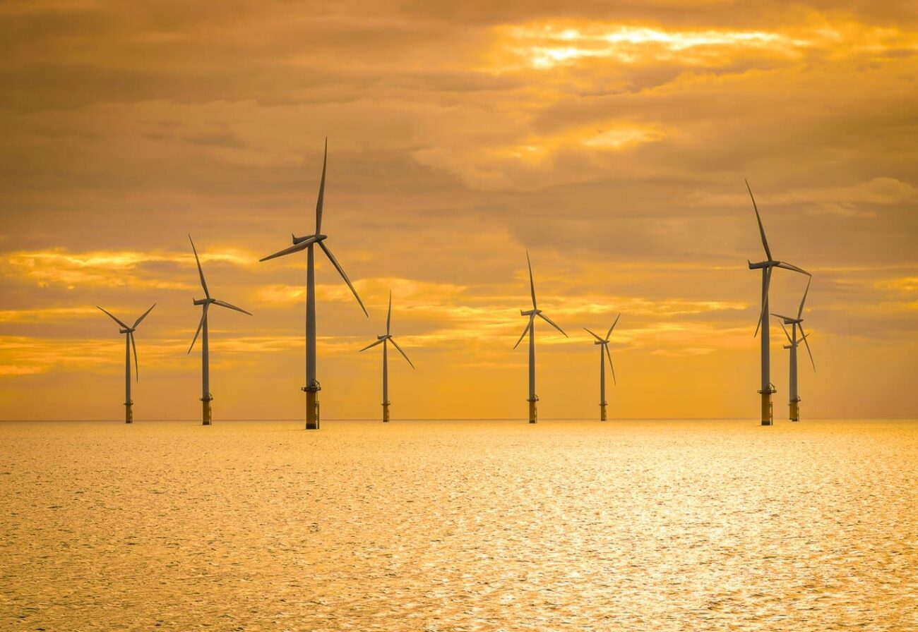 Sunset Offshore Wind Turbine in a Wind farm under construction on coast England